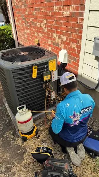 Technician troubleshooting an outdoor air conditioning unit beside a brick wall